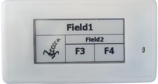 iot company A white electronic display showing options labeled Field1 and Field2, with buttons F3 and F4. An icon of a plant appears next to Field1.